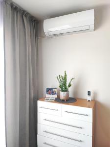 a white dresser with a plant on top of it at Chill House in Zator +41 photos