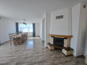 a living room with a table and a fireplace at Agroturystyka Julinka in Olszyny