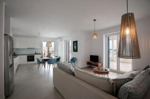 a living room with a couch and a table and a kitchen at Villa Sun in Naxos Chora