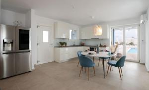 a kitchen and dining room with a table and chairs at Villa Sun in Naxos Chora