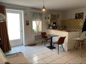 a kitchen with a table and chairs in a room at Meuble maison vigneronne in Saint-André-de-Sangonis