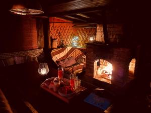 a living room with a fireplace and a couch at Útulná chaloupka na Valašsku in Valašská Bystřice