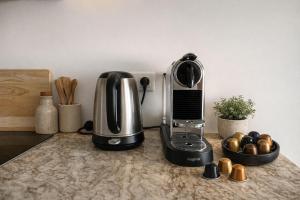 a kitchen counter with a coffee maker and a toaster at Solange by Port Azur Rental in Cogolin