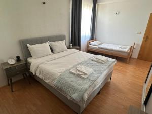 a bedroom with a bed with two towels on it at Apartman Mandurić in Posušje