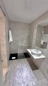 a bathroom with a sink and a mirror at Hotel Ciudad de Navalcarnero in Navalcarnero +28 photos