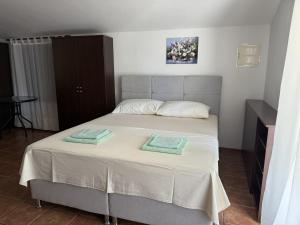a bedroom with a bed with two towels on it at Apartments Edita in Rogoznica +61 photos