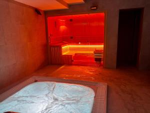 a bathroom with a tub in a room with a red light at Apartament GABA-NIECHORZE przy plaży, kryty basen in Niechorze