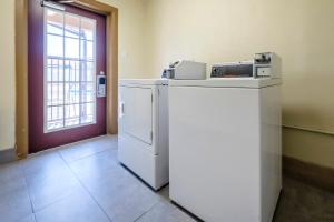 a kitchen with a refrigerator and a printer on top of it at Red Roof Inn Arlington - Entertainment District in Arlington