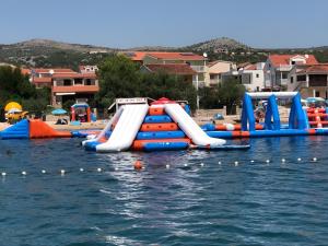 a group of inflatable slides in the water at Apartments Edita in Rogoznica