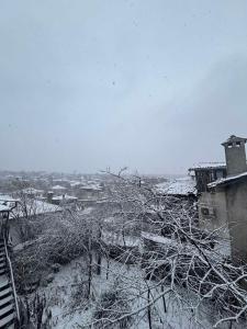 a snow covered city with houses and buildings at dato in Arbanasi