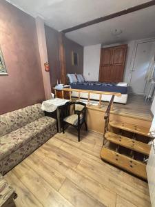 a room with a couch and a bed and a table at dato in Arbanasi +1 photo