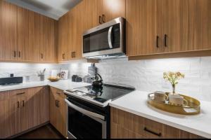 a kitchen with a stove and a microwave at SE Furnished Apartment in Atlanta +13 photos
