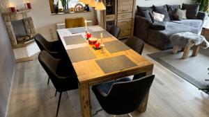 a dining room table with candles on it in a living room at Ferienhaus RENA mit Pool in Bischdorf