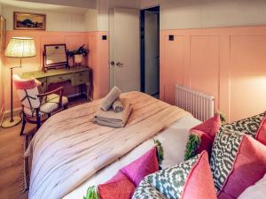a bedroom with a large wooden bed with a mirror at The Shepherd - Uk50613 in Sabden
