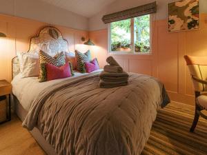 a bedroom with a large bed with colorful pillows at The Shepherd - Uk50613 in Sabden