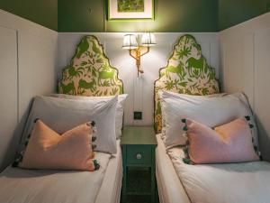 two beds with pillows sitting next to each other at The Shepherd - Uk50613 in Sabden +3 photos