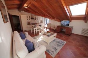 a living room with a white couch and a table at Casa Marcone in Deiva Marina