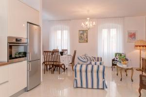 a kitchen and living room with a table and chairs at Villa Radovani Jelsa Hvar in Jelsa