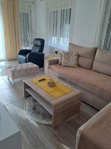 a living room with a couch and a coffee table at Stan na dan M in Smederevska Palanka +1 photo