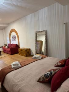 a bedroom with a large bed with a mirror at La Casa Gialla in Lucca +207 photos