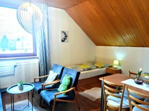 a small room with a bed and a table and chairs at Privat Mária in Liptovský Ján