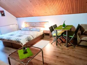 a bedroom with a bed and a desk and a table at Privat Mária in Liptovský Ján