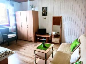 a living room with a couch and a table at Privat Mária in Liptovský Ján