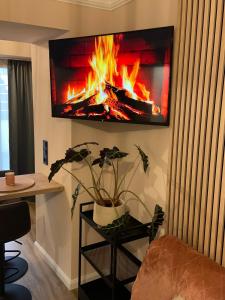 a living room with a fire on the wall at Modernes Studio in Irrel in Irrel