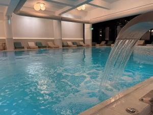 a pool with a water fountain in a hotel room at Splendid view Sinaia in Sinaia