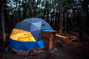 a tent sitting in the middle of a forest at Fitz Roy Comfort Camp - El Chaltén in El Chalten +32 photos