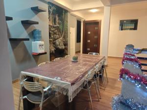a table and chairs in a room with a painting at Nature Lanka Guest House in Negombo