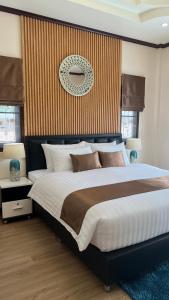 a bedroom with a large bed and a wall at Malinee Villa Phuket in Bang Tao Beach +64 photos