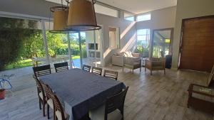 a dining room with a table and chairs in a house at Casa Azahares in Yerba Buena