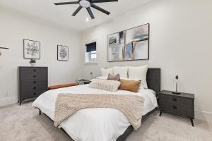 a bedroom with a large bed and a ceiling fan at The Brick & Beam Boutique Hotel in Collingwood