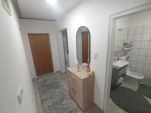 a bathroom with a sink and a mirror at Apartman Alić in Vogošća