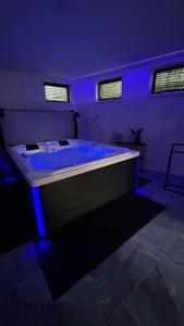 a room with a large tub with blue lights at Hideaway in Ostrava