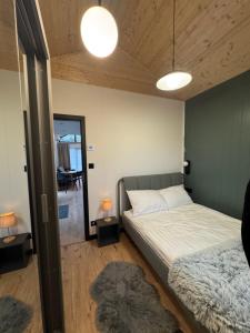 a bedroom with a bed and two lamps and a mirror at Pniówek Chill in Zamość