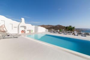 a swimming pool on the side of a villa at Princess Villas Oasis Mykonos in Kalafatis