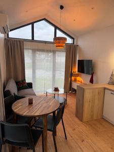 a living room with a table and a couch at Pniówek Chill in Zamość