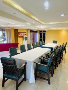 a large conference room with a long table and chairs at Las Vegas Garden Hotel-Kampala in Kampala +142 photos