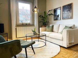 a living room with a white couch and a table at green rooms in Schweinfurt