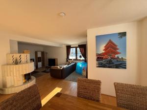 a living room with a couch and a fireplace at Haus mit Sauna, Garten und Pool in Sangerhausen