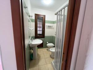 a bathroom with a toilet and a sink at B&B Agrodolce in San Vito lo Capo +22 photos