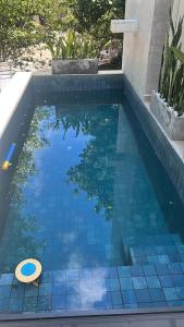 a swimming pool with a blue tiled floor and a swimming pool at Condômino Max life in Pipa