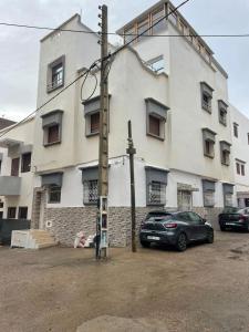 a car parked in front of a building at Roots Surf House - Anza in Agadir
