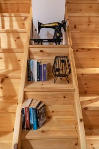 a stairwell with a book shelf with a drill at Diolanth traditional house in Koskinou