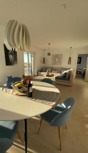 a living room with a table and chairs and a couch at Villa Sun in Naxos Chora