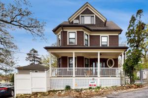 a house with a white fence in front of it at 3 Mi to Franklin Park Zoo! Bright Residential Stay in Boston