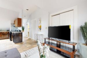a living room with a large flat screen tv at 3 Mi to Franklin Park Zoo! Bright Residential Stay in Boston