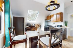 a kitchen with a wooden table and chairs in a kitchen at 3 Mi to Franklin Park Zoo! Bright Residential Stay in Boston